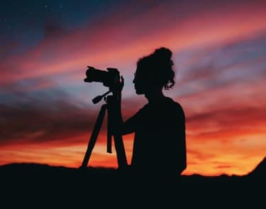 Silhouette photographer at sunset