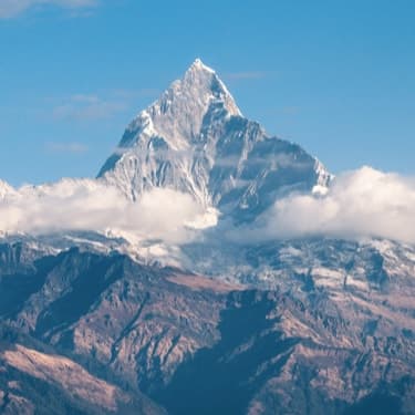 Snow-covered mountain peak under a blue sky